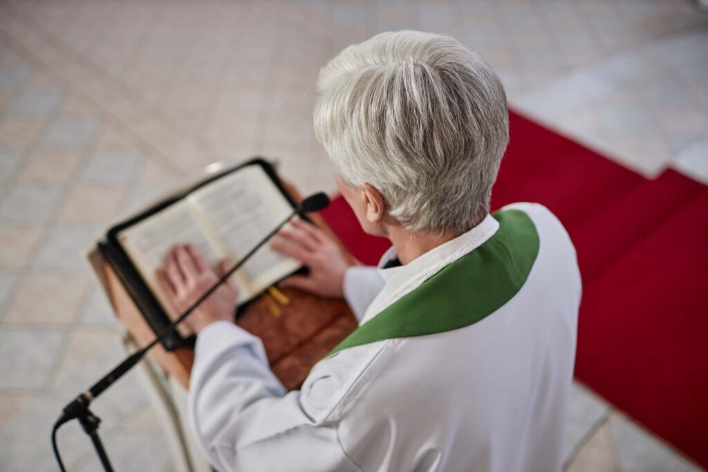 priest-reading-bible-during-ceremony-in-church-JQ7CNQF.jpg
